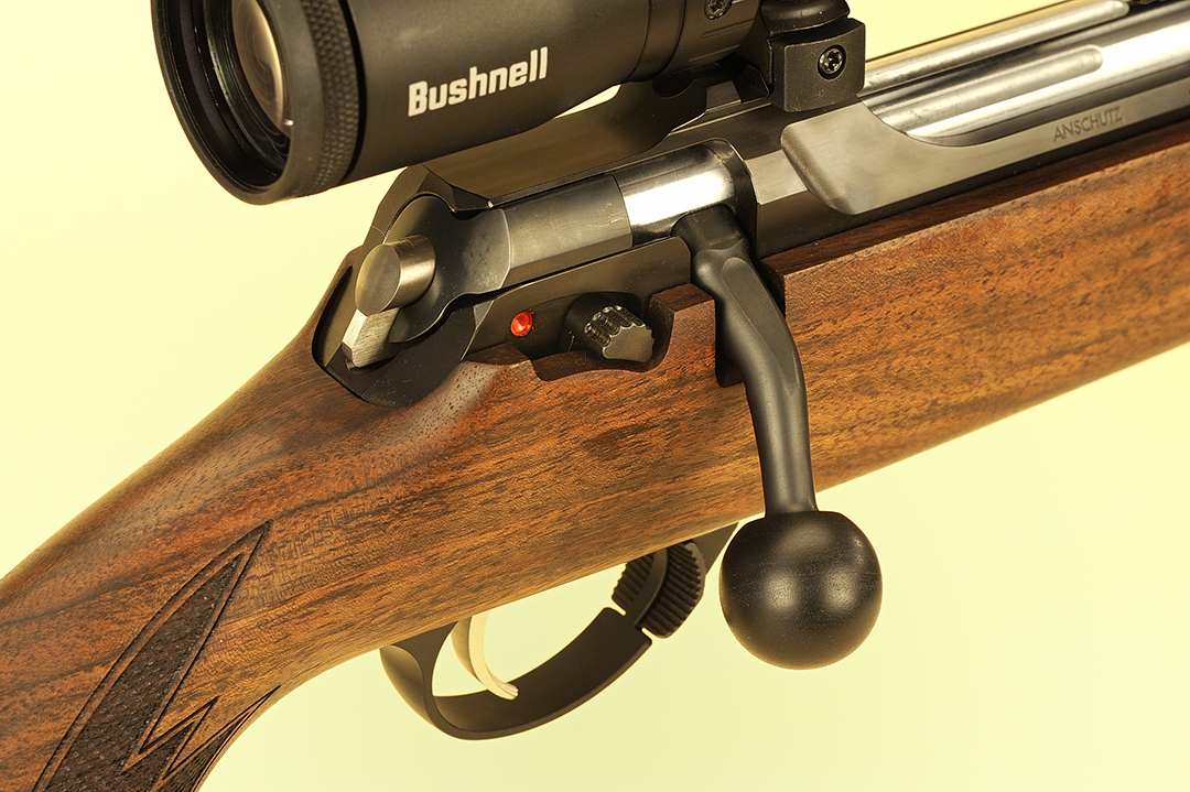 With the rifle cocked, you can see the firing pin indicator protruding from the bolt shroud. The 2-position safety lever is to the right, the bolt with the angled handle and enlarged knob and the adjustable trigger.